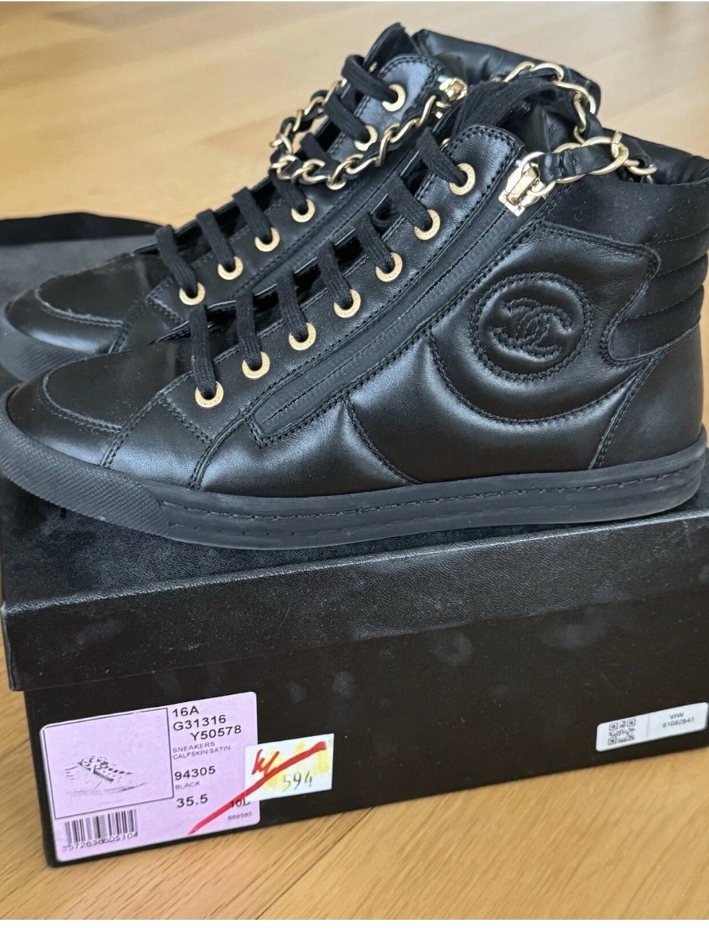 CHANEL Black Quilted High-Top Leather Sneakers with Gold Hardware